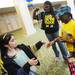 Michigan alumni Kyla Ross and Lailah Ross, 9, both of Atlanta, receive beads before going into the Michigan Alumni pep rally at the Renaissance Atlanta Waverly Hotel in Atlanta on Friday, April 5, 2015. Melanie Maxwell I AnnArbor.com
